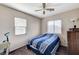 This Bedroom has natural light, a ceiling fan, and a dark wooden dresser at 5228 Fire Night Ave, Las Vegas, NV 89122