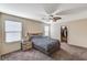 Comfortable bedroom with a ceiling fan, closet, and bedside table with lamp at 5228 Fire Night Ave, Las Vegas, NV 89122