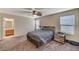 Spacious primary bedroom with ceiling fan, en-suite bathroom, and neutral carpet at 5228 Fire Night Ave, Las Vegas, NV 89122