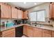 Efficient kitchen with modern black appliances and light wood-finished cabinetry at 5228 Fire Night Ave, Las Vegas, NV 89122