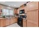Efficient kitchen with modern black appliances and light wood-finished cabinetry at 5228 Fire Night Ave, Las Vegas, NV 89122