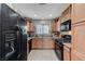 Efficient kitchen with modern black appliances and light wood-finished cabinetry at 5228 Fire Night Ave, Las Vegas, NV 89122
