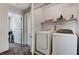Bright laundry room featuring a washer, dryer, and storage shelving at 5228 Fire Night Ave, Las Vegas, NV 89122