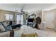 Comfortable living room featuring neutral tile flooring and a sliding glass door at 5228 Fire Night Ave, Las Vegas, NV 89122