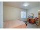 Bright bedroom with a bed, vanity, sheer curtains, and wood-look floors at 533 Date St, Boulder City, NV 89005