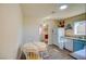 Charming kitchen with blue cabinets, breakfast nook, and wood-look floors offers bright and inviting space at 533 Date St, Boulder City, NV 89005
