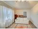 Bright living room featuring a white sofa, patterned rug, and large window with sheer curtains at 533 Date St, Boulder City, NV 89005