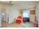 Cozy living room showcasing a comfortable red chair, area rug, and natural light from window at 533 Date St, Boulder City, NV 89005