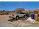 View of a parked white pickup truck under a covered parking area, surrounded by other parked vehicles and external storage at 533 Date St, Boulder City, NV 89005