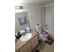 Modest bathroom featuring a vanity with an oval sink, toilet with purple seat cover and tiled shower at 555 E Silverado Ranch Blvd # 2028, Las Vegas, NV 89183