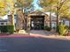 Apartment complex leasing office featuring stonework and a covered entryway with a stone monument in front at 555 E Silverado Ranch Blvd # 2028, Las Vegas, NV 89183