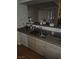 A clean kitchen featuring a stainless steel sink, light wood cabinets and plenty of countertop workspace at 555 E Silverado Ranch Blvd # 2028, Las Vegas, NV 89183