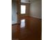 Bright living room featuring shiny hardwood floors and a large window with natural light at 555 E Silverado Ranch Blvd # 2028, Las Vegas, NV 89183