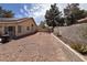 This cozy backyard features a low-maintenance landscape with a gravel-covered ground and block fence at 5638 Morning Song Cir, North Las Vegas, NV 89031