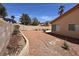 This cozy backyard features a low-maintenance landscape with a gravel-covered ground and block fence at 5638 Morning Song Cir, North Las Vegas, NV 89031