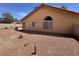 This cozy backyard features a low-maintenance landscape with a gravel-covered ground and block fence at 5638 Morning Song Cir, North Las Vegas, NV 89031