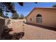 This cozy backyard features a low-maintenance landscape with a gravel-covered ground and block fence at 5638 Morning Song Cir, North Las Vegas, NV 89031