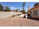This cozy backyard features a low-maintenance landscape with a gravel-covered ground, patio and block fence at 5638 Morning Song Cir, North Las Vegas, NV 89031