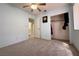 Carpeted bedroom includes closet, ceiling fan, and view to the bathroom at 5638 Morning Song Cir, North Las Vegas, NV 89031