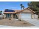 Charming single-story home with a two-car garage, desert landscaping, and a terracotta roof at 5638 Morning Song Cir, North Las Vegas, NV 89031