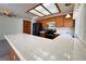 Updated kitchen features tile floors, extended breakfast bar, wood cabinets, and stainless-steel appliances at 5638 Morning Song Cir, North Las Vegas, NV 89031