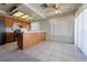Eat-in kitchen features tile floors, breakfast bar, wood cabinets, bright lighting, and view to the outdoors at 5638 Morning Song Cir, North Las Vegas, NV 89031