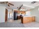 Bright eat-in kitchen boasts tile floors, breakfast bar, updated appliances, wood cabinets, and view to adjacent carpeted room at 5638 Morning Song Cir, North Las Vegas, NV 89031