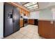 Updated kitchen with tile floors, breakfast bar, wood cabinets, and stainless-steel appliances at 5638 Morning Song Cir, North Las Vegas, NV 89031