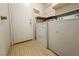 This laundry room includes a washer and dryer with built-in shelving at 5638 Morning Song Cir, North Las Vegas, NV 89031