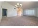Open-concept living room featuring neutral carpet and ample light, creating a warm atmosphere at 5638 Morning Song Cir, North Las Vegas, NV 89031