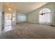 Spacious living room with tile entry, neutral carpet, a chandelier, and large windows for ample lighting at 5638 Morning Song Cir, North Las Vegas, NV 89031