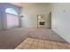 Open-concept living room features neutral carpet, and seamless flow to other rooms with a chandelier at 5638 Morning Song Cir, North Las Vegas, NV 89031