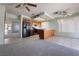 View of kitchen and adjacent living area. Features tile flooring and black appliances at 5638 Morning Song Cir, North Las Vegas, NV 89031