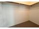 Inside the empty walk-in closet with carpet flooring and hanging rod at 5638 Morning Song Cir, North Las Vegas, NV 89031