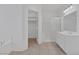 Bright primary bathroom featuring tiled floors, shower, bathtub and ample closet space at 5808 Spinnaker Reach Ave, Las Vegas, NV 89130