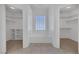 Bright primary bathroom with separate closets, bathtub, and tiled floors at 5808 Spinnaker Reach Ave, Las Vegas, NV 89130
