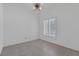 Well-lit bedroom with ceiling fan, shuttered windows, and tile flooring at 5808 Spinnaker Reach Ave, Las Vegas, NV 89130