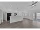 Open concept kitchen with white cabinets, stainless steel appliances, and sliding glass doors at 5808 Spinnaker Reach Ave, Las Vegas, NV 89130