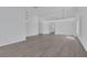 Spacious open-concept living area with fresh white walls, gray wood floors, and modern lighting at 5808 Spinnaker Reach Ave, Las Vegas, NV 89130