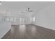 Open living area featuring sliding glass doors to backyard, shuttered windows, and freshly painted white walls at 5808 Spinnaker Reach Ave, Las Vegas, NV 89130
