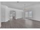 Bright living room showcasing freshly painted white walls, gray wood floors, modern lighting, and shuttered windows at 5808 Spinnaker Reach Ave, Las Vegas, NV 89130