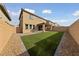Well-maintained backyard featuring artificial turf, patio, and privacy walls at 595 Beverly Pine Pl, Henderson, NV 89011