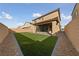 Spacious backyard with artificial turf, patio, and access to the side yard at 595 Beverly Pine Pl, Henderson, NV 89011