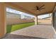 Inviting covered patio with brick pavers and a ceiling fan overlooking the lawn at 595 Beverly Pine Pl, Henderson, NV 89011