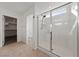Modern bathroom with glass shower, tile flooring and walk-in closet with closet organizers at 595 Beverly Pine Pl, Henderson, NV 89011