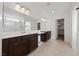 Primary bathroom with double vanity, white countertops, and tiled floor with walk-in shower at 595 Beverly Pine Pl, Henderson, NV 89011