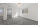 Upstairs bedroom with plush gray carpet, neutral walls, and windows overlooking the neighborhood at 595 Beverly Pine Pl, Henderson, NV 89011