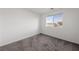 Cozy bedroom with soft carpet and a window offering neighborhood views at 595 Beverly Pine Pl, Henderson, NV 89011