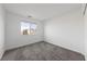 Bright bedroom with soft carpet and a window offering neighborhood views at 595 Beverly Pine Pl, Henderson, NV 89011