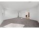Open bonus room with plush gray carpet, bright white walls, and natural light at 595 Beverly Pine Pl, Henderson, NV 89011